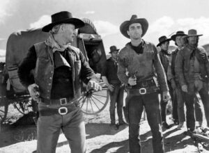 black and white image of cowboys with guns drawn - when conflict arises